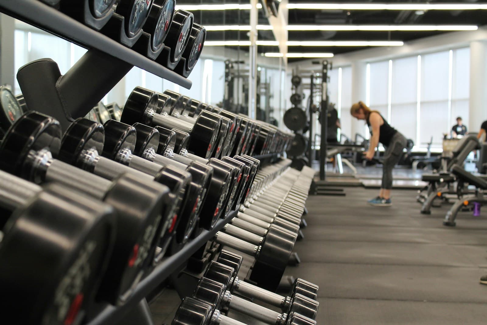 Athlete training with free weights in a gym